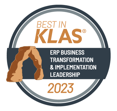 A circle logo that says Best in Klas (trademark) - ERP Business Transformation and Implementation Leadership 2023, with a drawing of a natural brown stone archway.