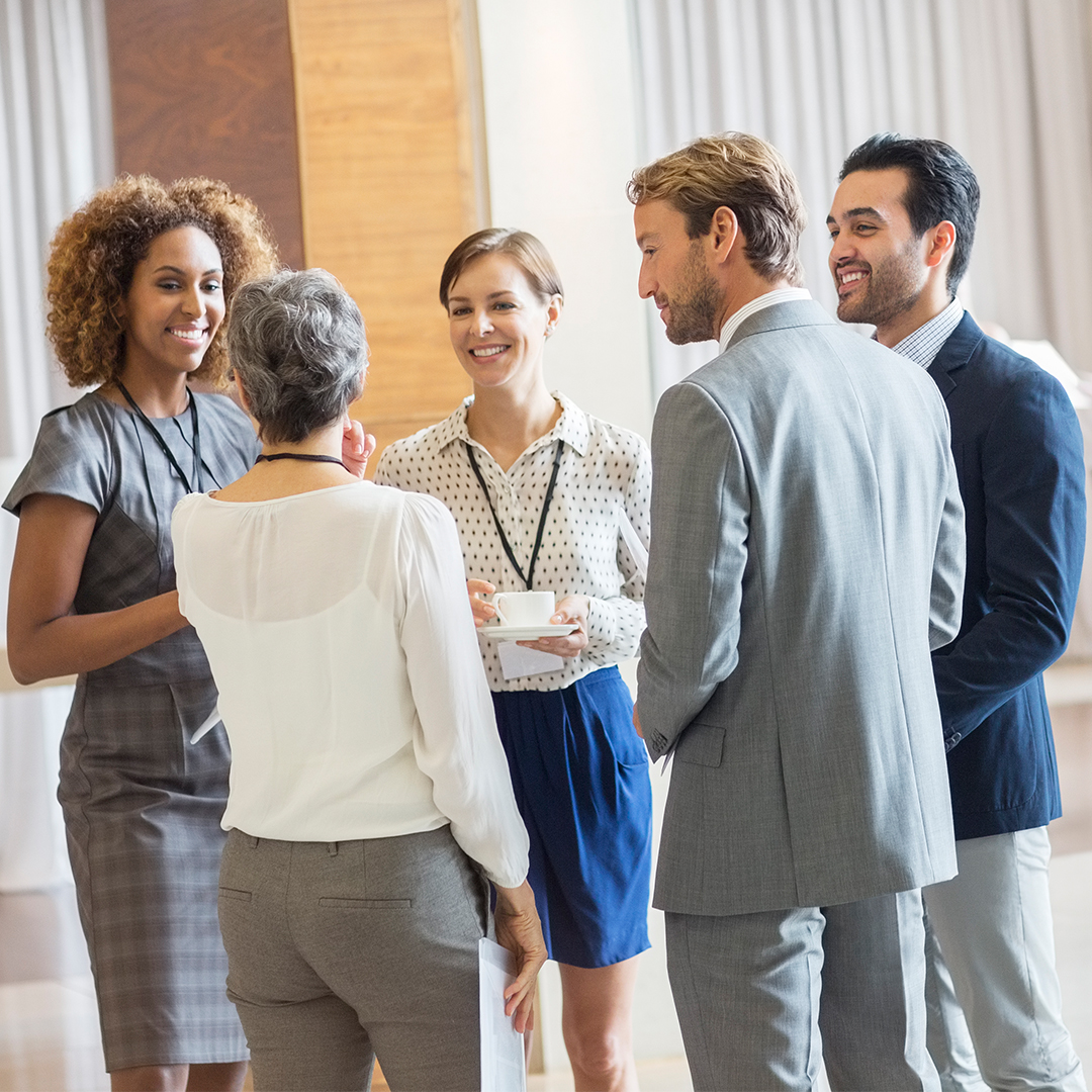 A group of people conversating/networking