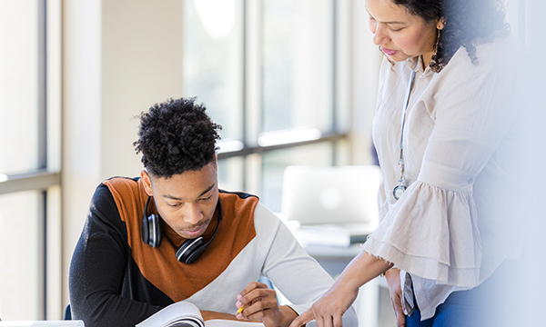An image of a teach checking in on a student