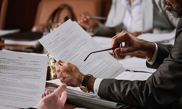 A still shot of a man reviewing a piece of paper