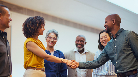 A group of people introducing themselves and handshaking