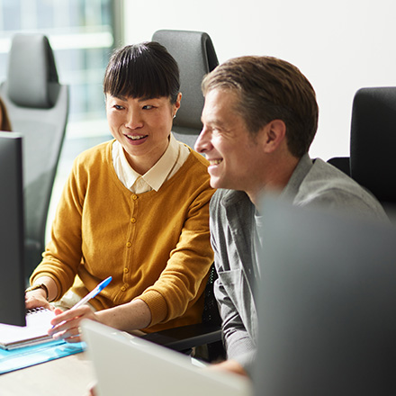Two people sitting close and looking deep in conversation