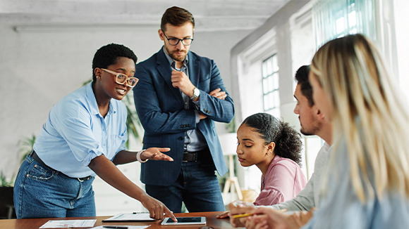 A group of leaders talking to what looks like students in a training session