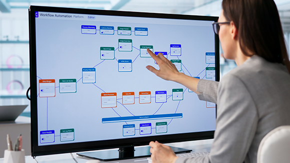 A woman looking at a screen with diagrams 