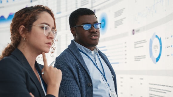 A man and women looking at a data screen
