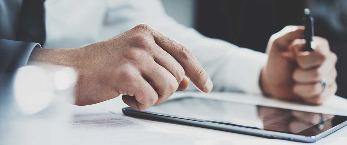Hand hovering over iPad